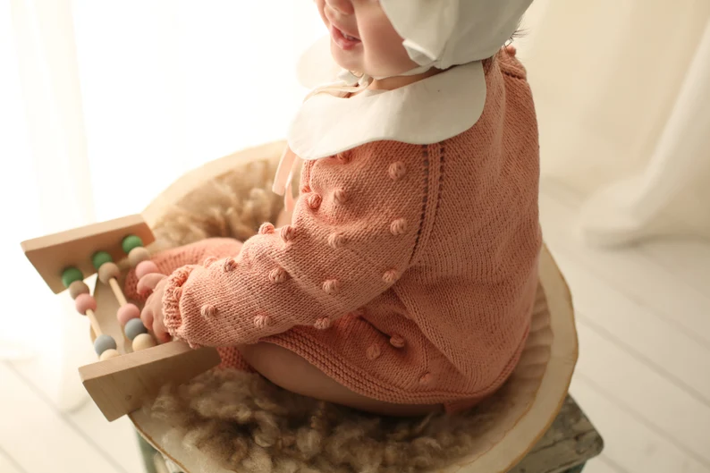 Baby pink organic cotton knit cardigan with bobble texture for newborn to twelve months