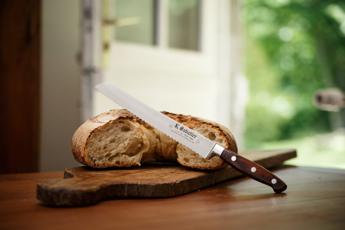 Sabatier bread knife with serrated blade and brown wooden handle