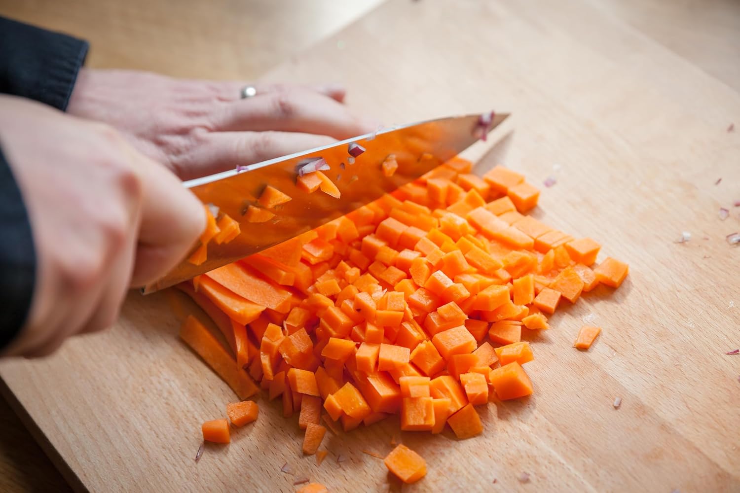 Judge Sabatier 5 piece knife block set with orange handle knife chopping carrots