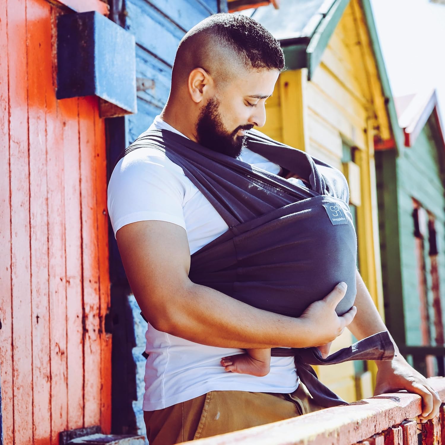 Dreamgenii Snuggleroo baby carrier in charcoal grey, worn by parent