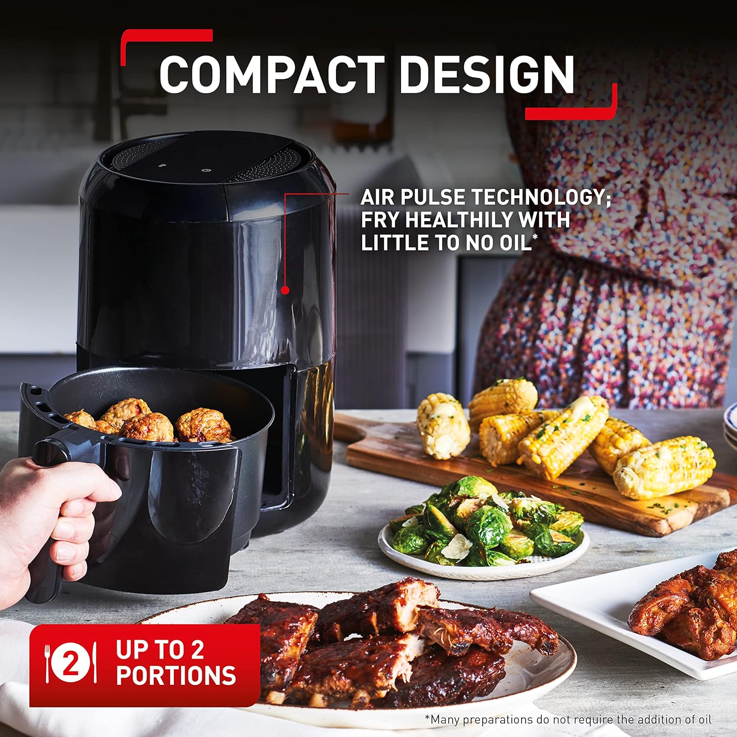TEFAL Easy Fry Compact black air fryer with removable basket showing cooked food