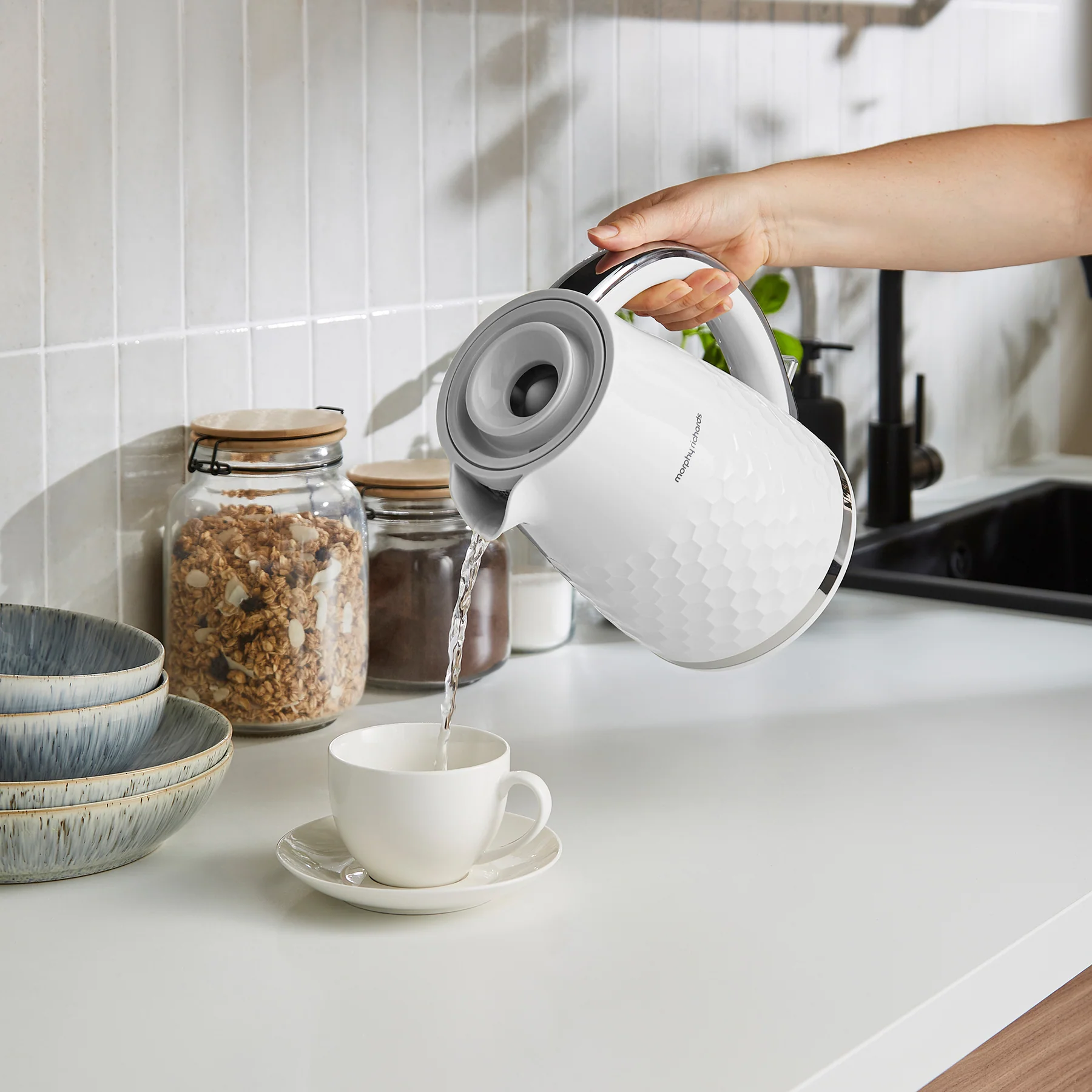 Morphy Richards Hive white jug kettle pouring hot water into cup