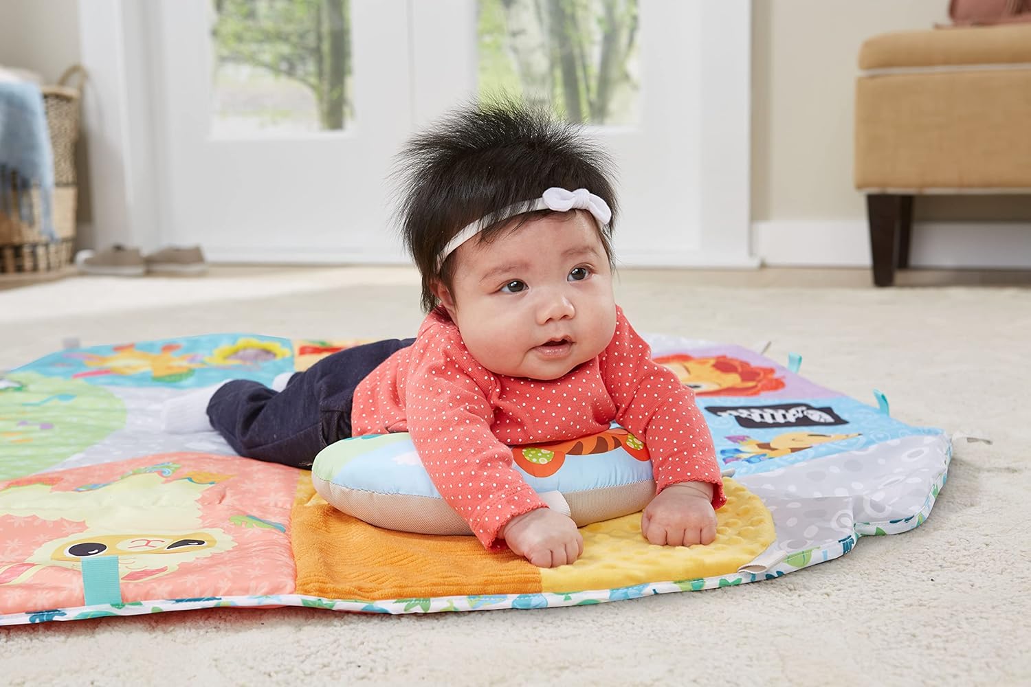 I can see the image shows a baby on a colourful play mat, but this does not match the product name "Joie Snacker 2-in-1 Highchair" provided. The image appears to be a play mat, not a highchair.

Based on what's actually visible in the image:

Colourful baby play mat with animal and pattern designs