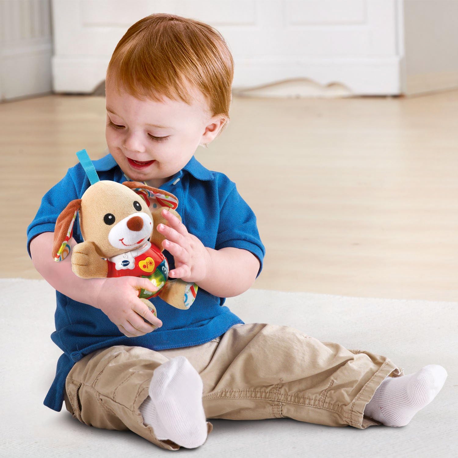 VTech Little Singing Puppy brown and cream plush toy with red shirt