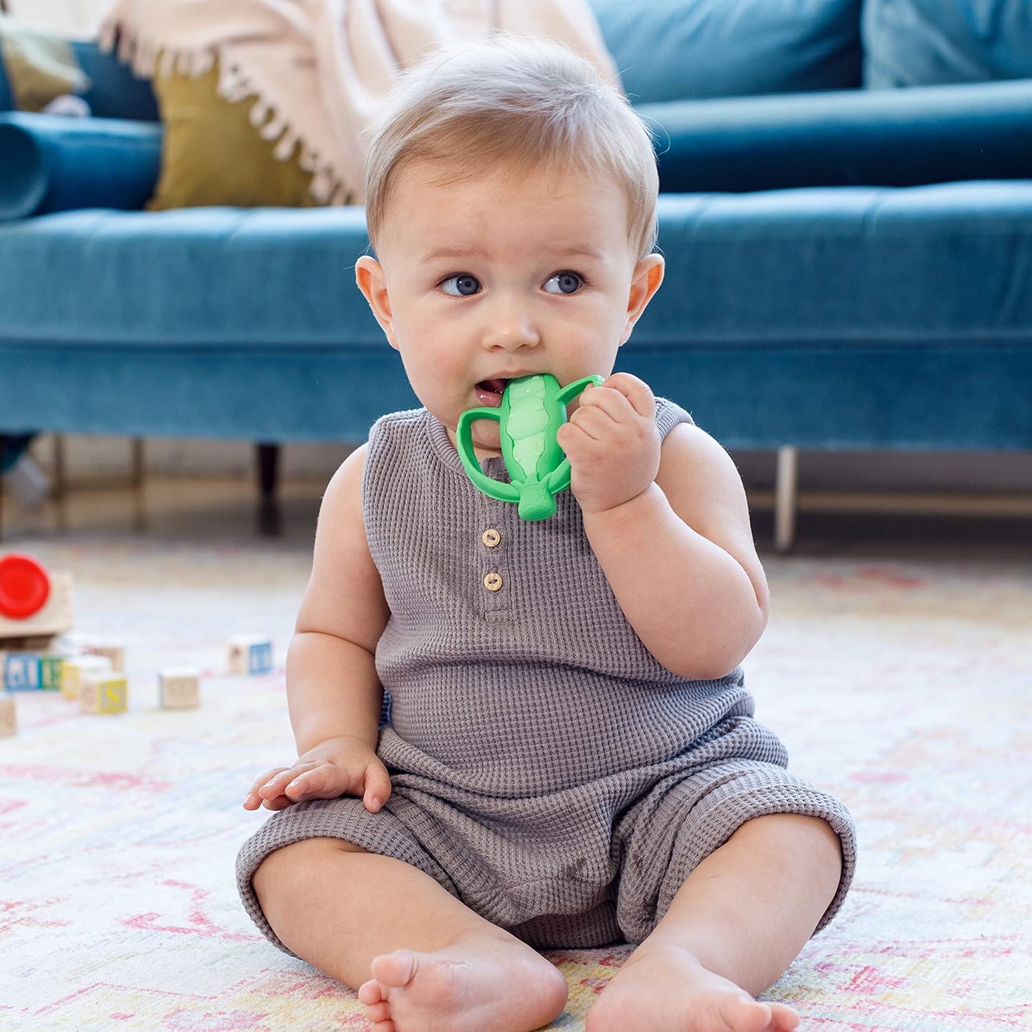 Infantino Lil' Nibbles green silicone teether with textured surface for babies