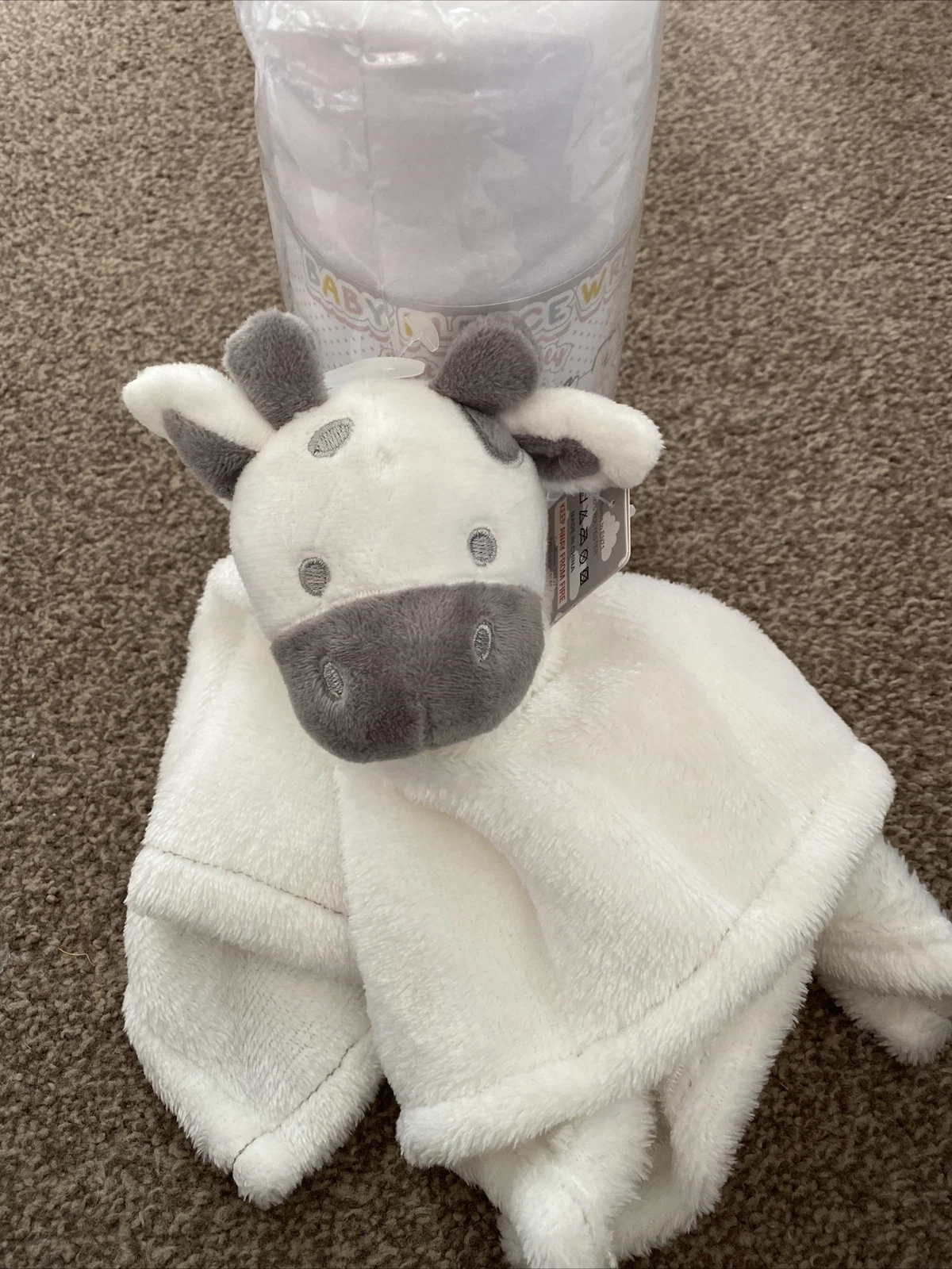 Soft Touch Infant Wrap white and grey cow plush toy with packaging