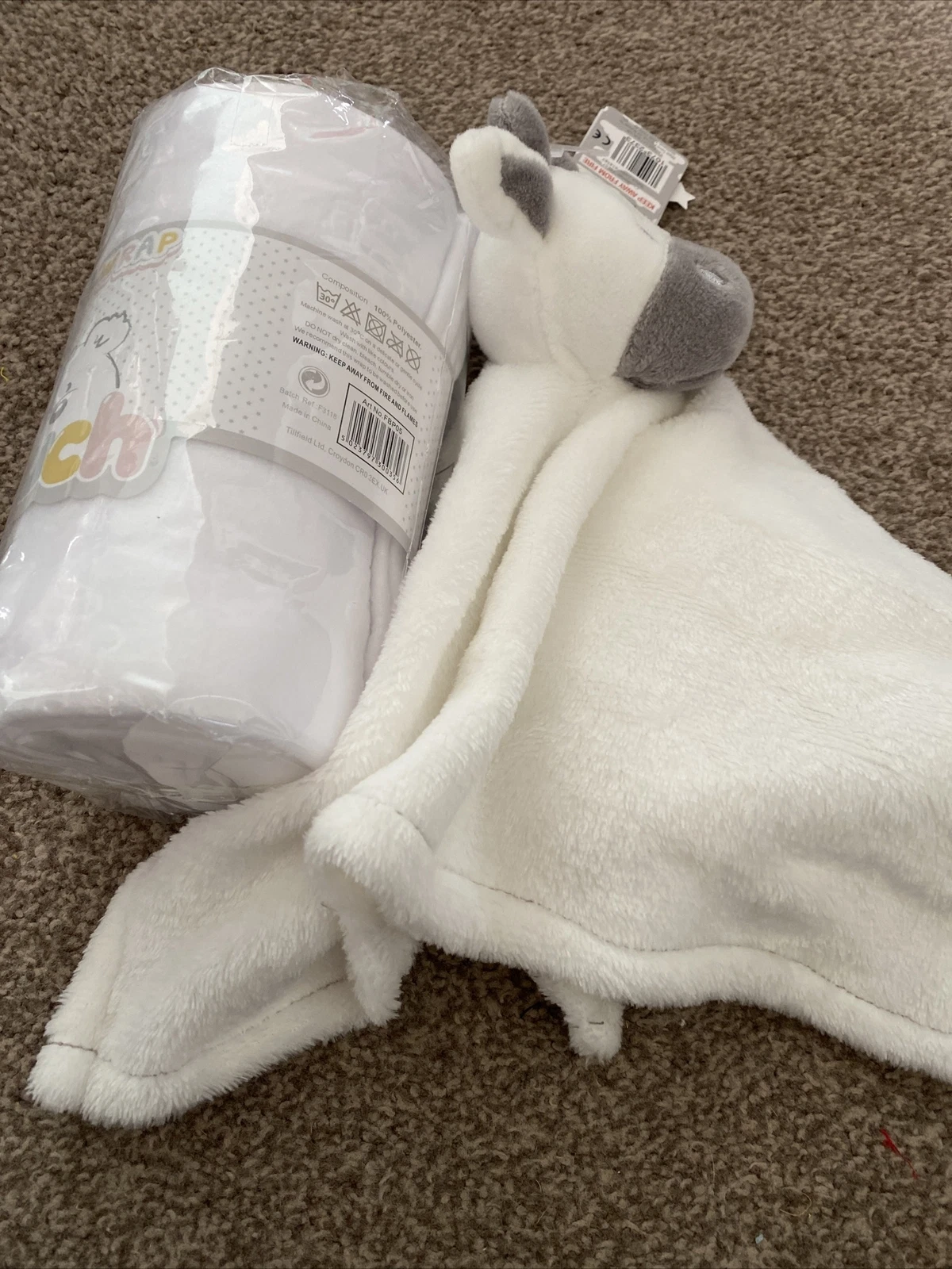 Soft Touch Infant Wrap white and grey plush with packaging roll displayed