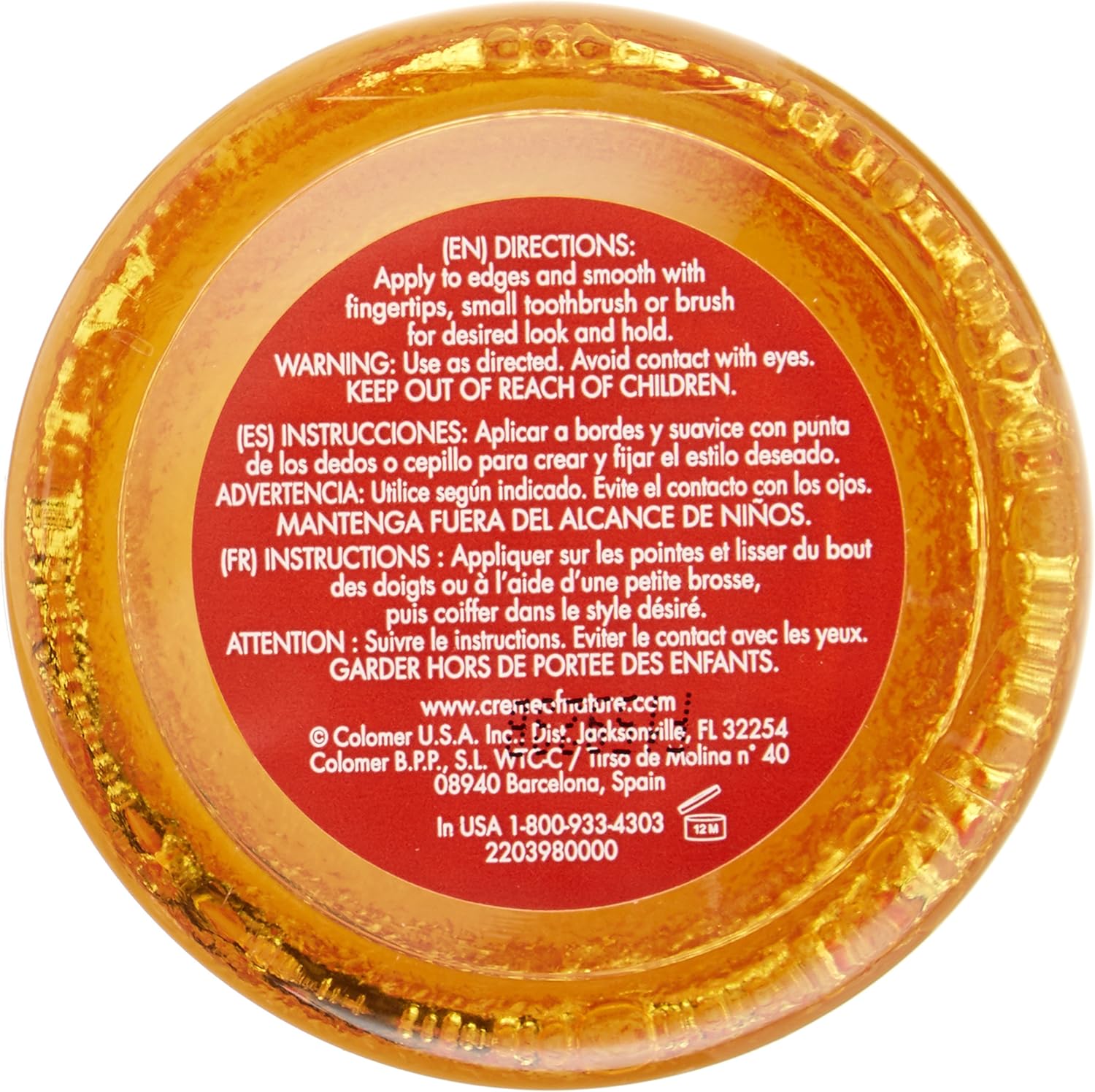 Creme Of Nature hair edge control gel in golden container with red label