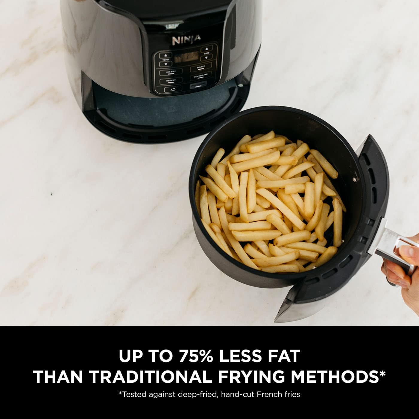 Ninja 3.8L black air fryer and dehydrator with cooked chips in basket