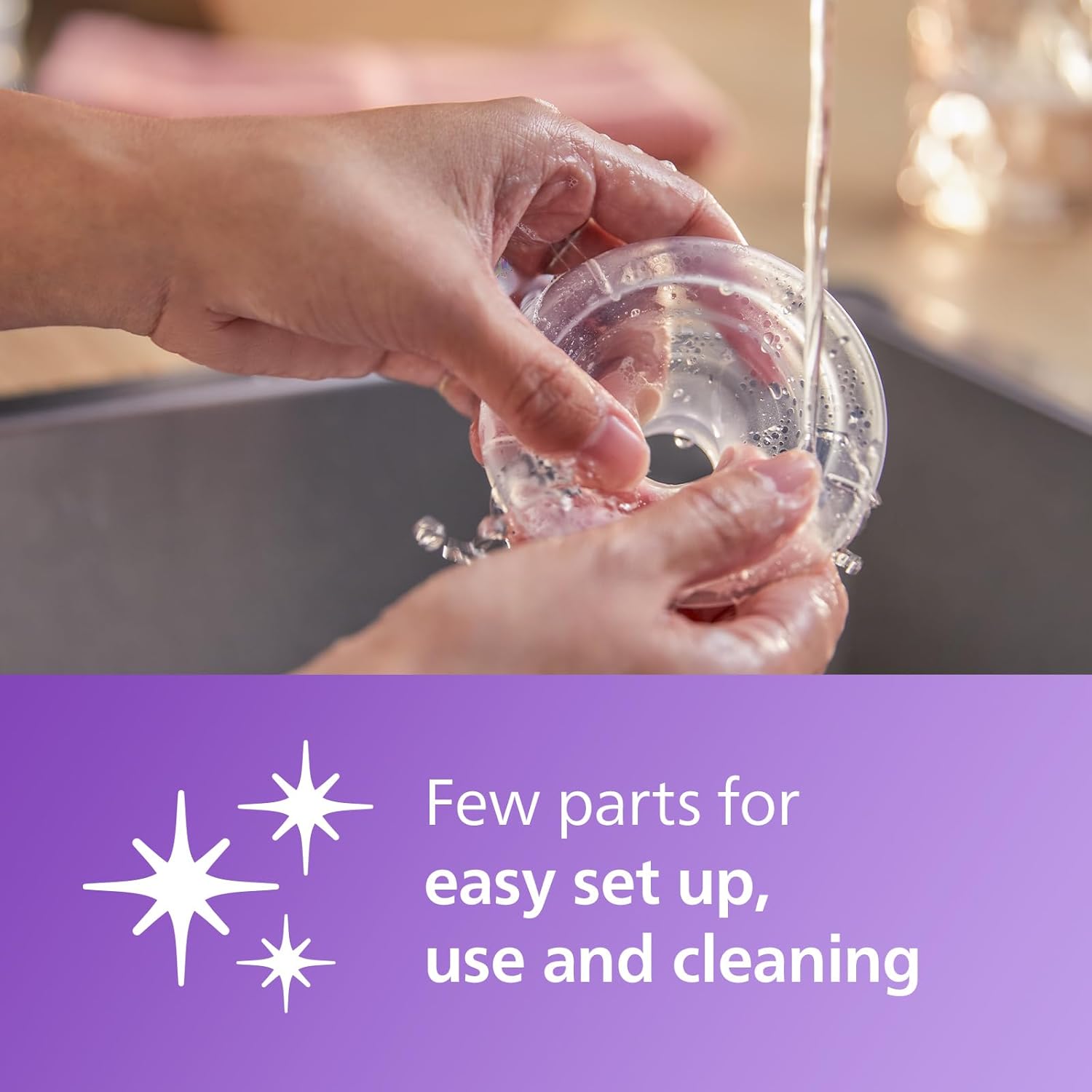 Philips Avent manual breast pump with collection bottle being rinsed under water