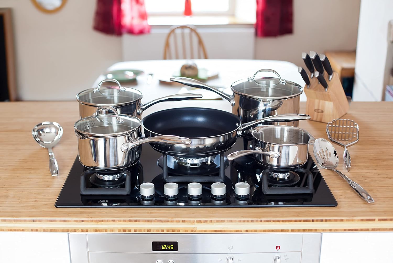 Stellar 7000 stainless steel five-piece saucepan set with glass lids and draining strainer lids