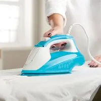 Russell Hobbs Light & Easy Brights aqua and white steam iron on board