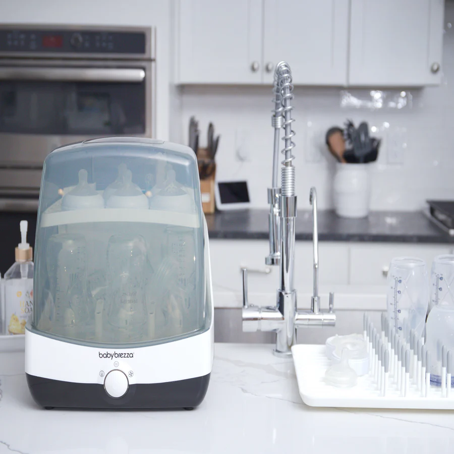 Baby Brezza Superfast Steriliser-Dryer with clear dome and white base on kitchen counter